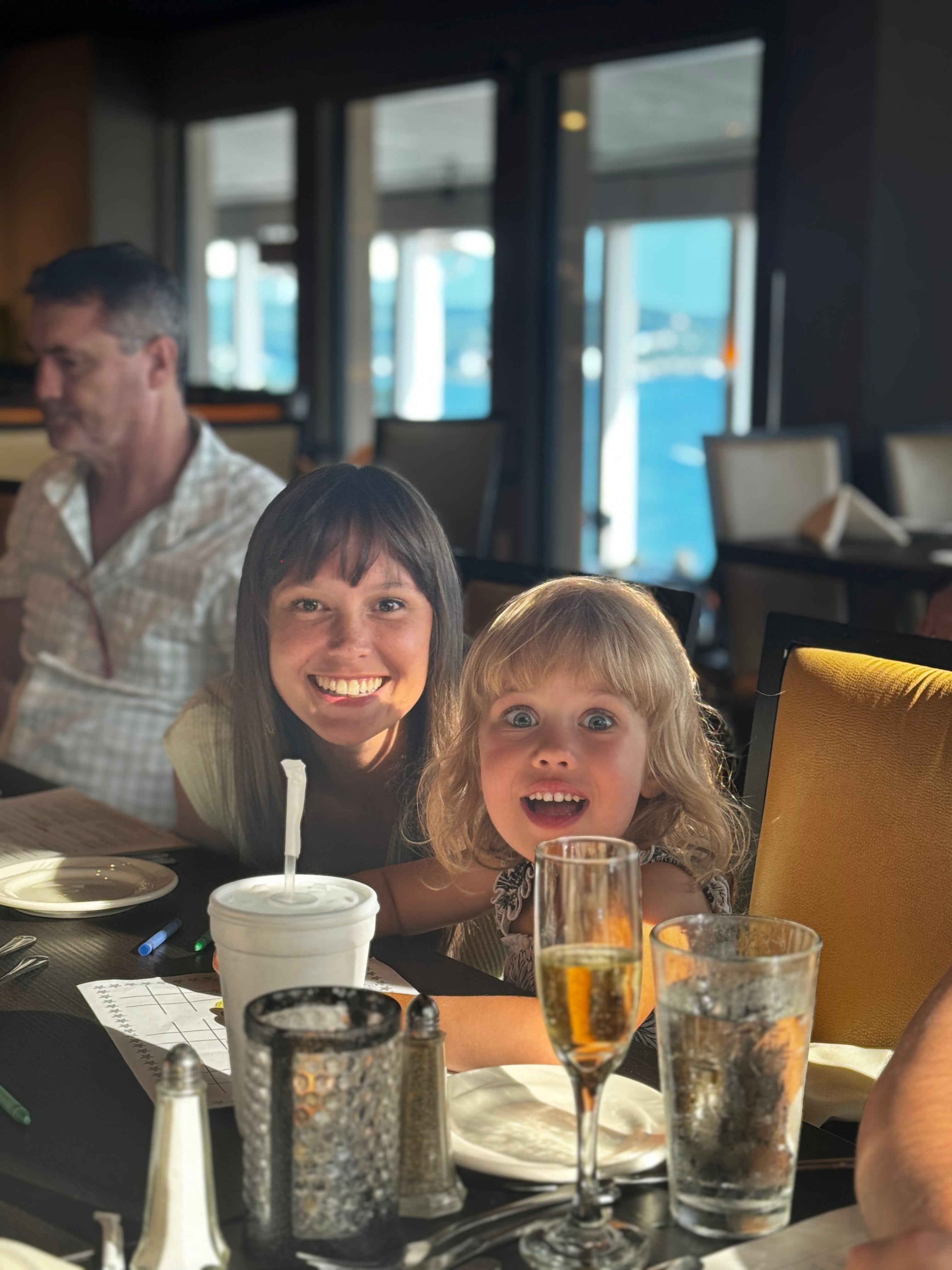 Mom and daughter smiling at dinner