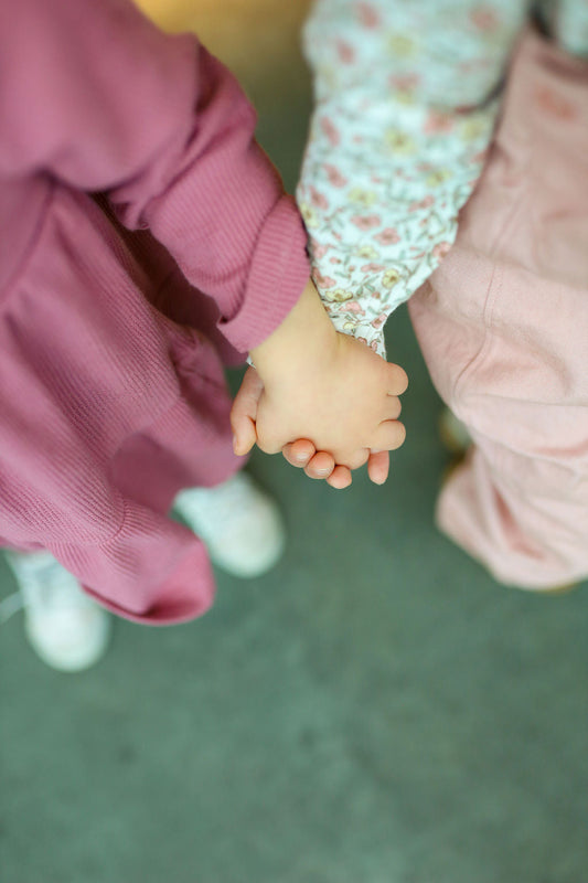 little girls holding hands